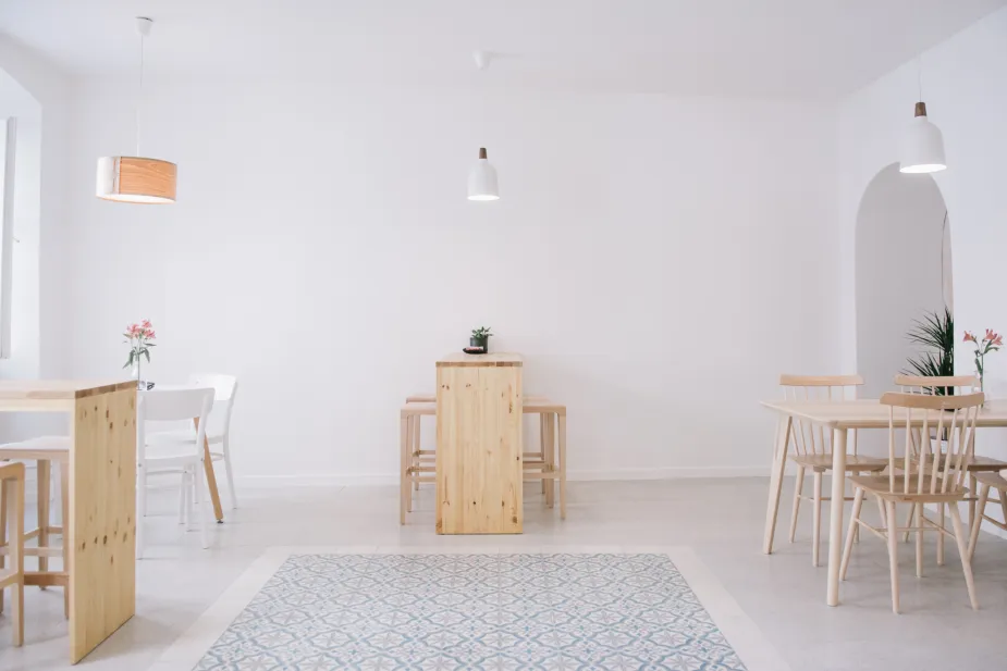 A serene and minimalist interior with a predominantly white palette.