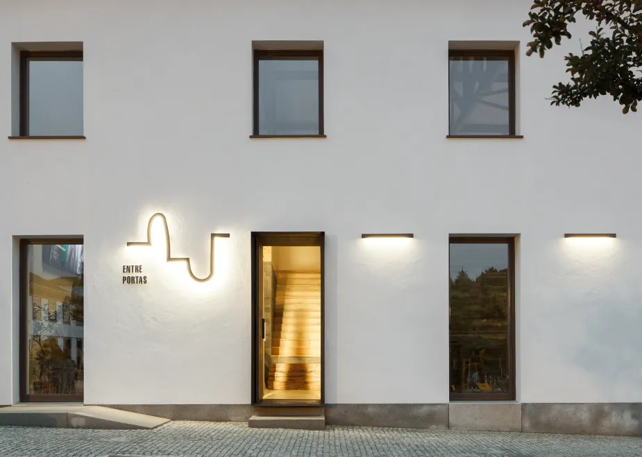 A big white wall with windows and doors 
