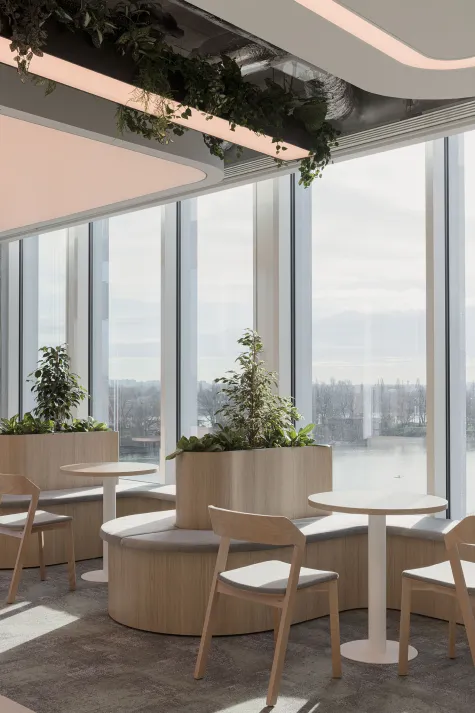 Modern office break area with large windows showcasing a city view