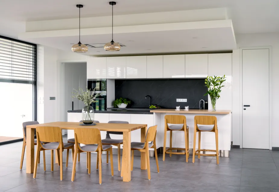 A modern kitchen with sleek, clean lines and natural furniture