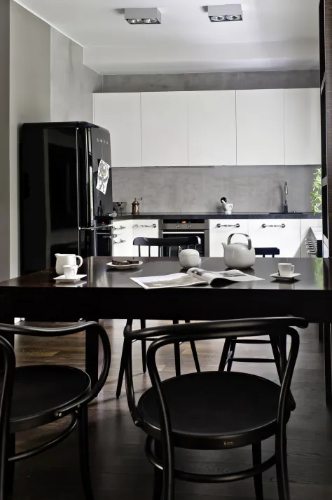 Elegant black dining chair in a white-themed room