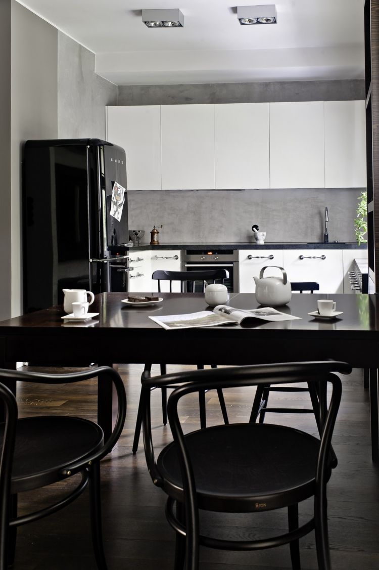 Elegant black dining chair in a white-themed room
