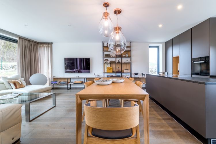 Elegant home interior featuring a modern kitchen and the Merano chair and armchair