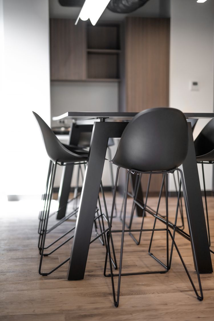 A black table surrounded by high bar stools